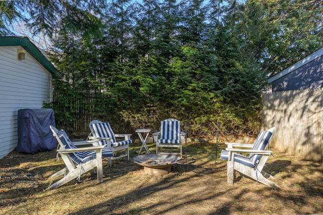 view of yard featuring fence and an outdoor fire pit