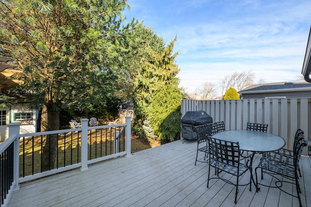 wooden terrace with outdoor dining space