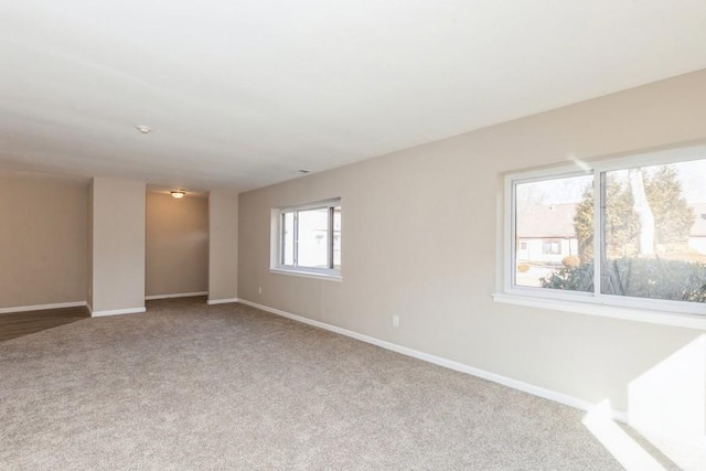 empty room featuring carpet flooring and baseboards