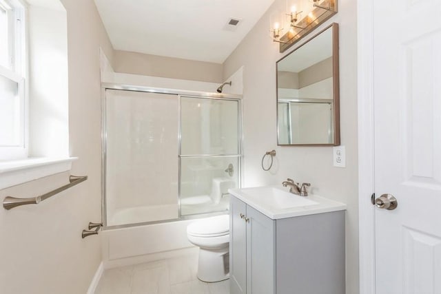 full bath featuring toilet, baseboards, bath / shower combo with glass door, and vanity