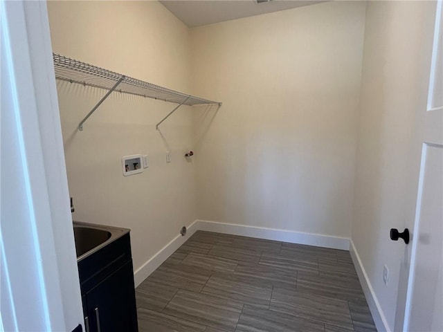 laundry room with laundry area, hookup for a washing machine, and baseboards