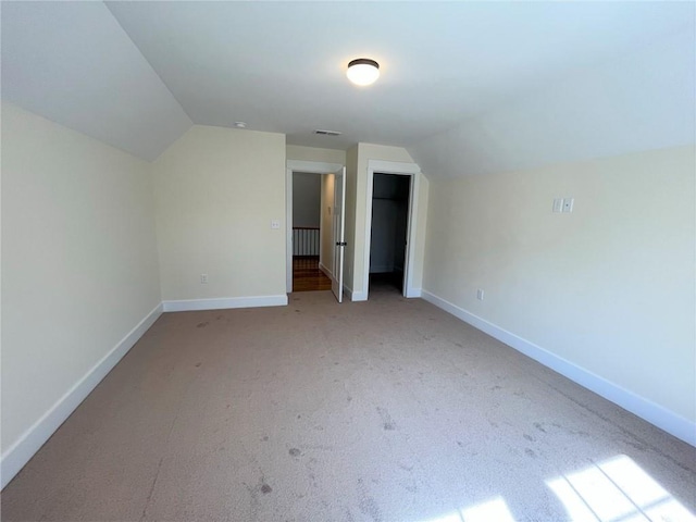 bonus room with lofted ceiling, carpet flooring, visible vents, and baseboards