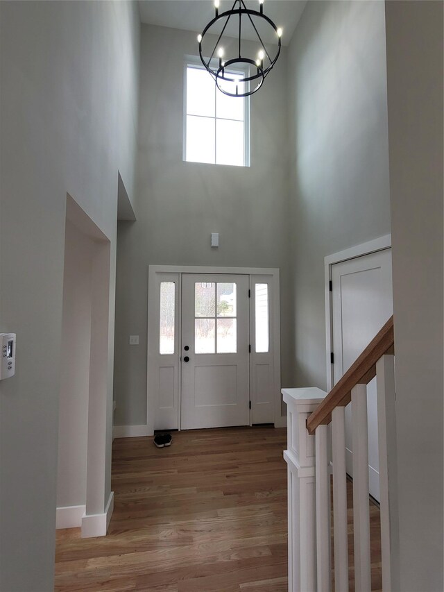 472 Wheeler Rd, Florida, NY 10921 - entrance foyer featuring light wood-style floors, baseboards, a chandelier, and a towering ceiling