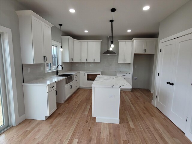 472 Wheeler Rd, Florida, NY 10921 - kitchen featuring wall chimney range hood, tasteful backsplash, a sink, and a center island