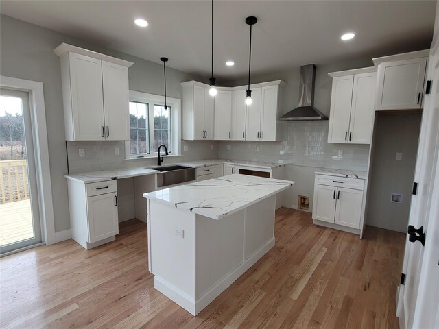 472 Wheeler Rd, Florida, NY 10921 - kitchen featuring wall chimney range hood, backsplash, a sink, and light wood finished floors