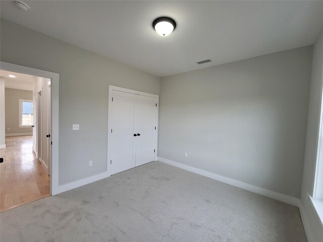472 Wheeler Rd, Florida, NY 10921 - unfurnished bedroom featuring baseboards, visible vents, a closet, and light colored carpet