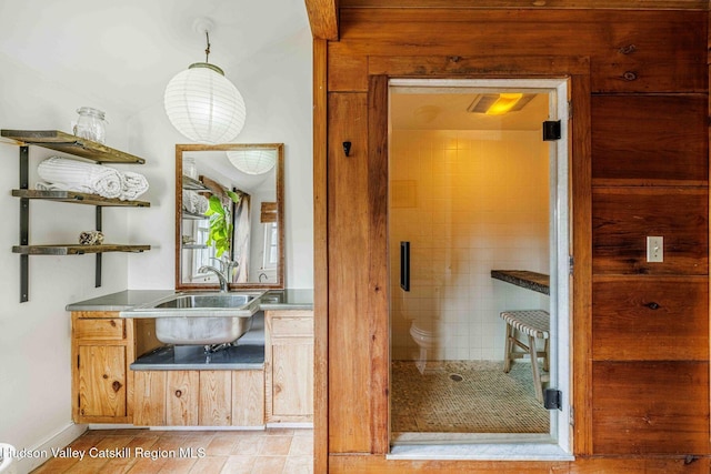 full bathroom featuring a shower stall and a sink