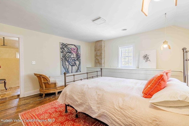 bedroom featuring wood finished floors and baseboards