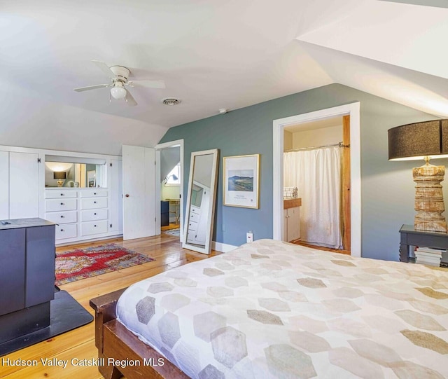 bedroom with light wood-type flooring, visible vents, ceiling fan, and vaulted ceiling