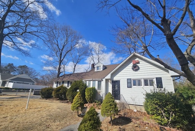 new england style home with fence