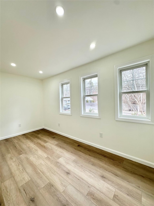 unfurnished room featuring recessed lighting, baseboards, and wood finished floors