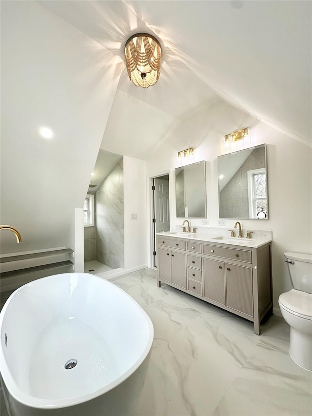 full bathroom with a freestanding tub, lofted ceiling, marble finish floor, and a sink