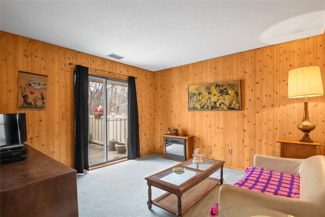 living area featuring visible vents and carpet floors