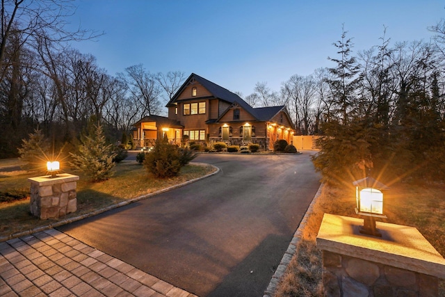 view of front of home featuring curved driveway and covered porch