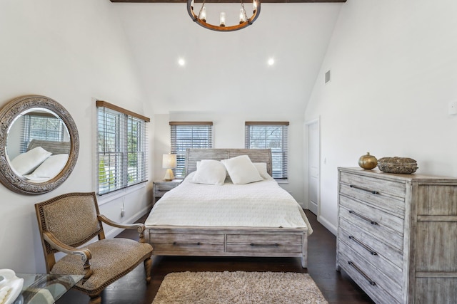 bedroom featuring visible vents, multiple windows, an inviting chandelier, and dark wood-style floors