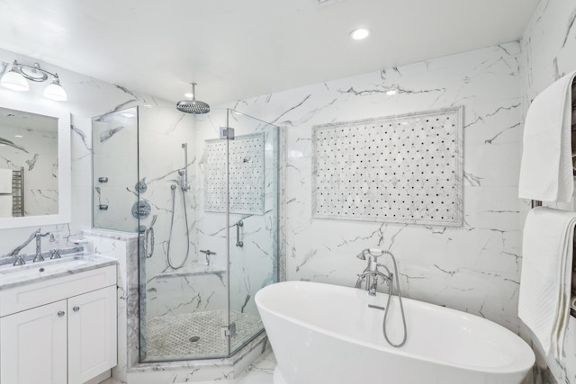 bathroom with vanity, stone wall, a marble finish shower, a freestanding tub, and marble finish floor