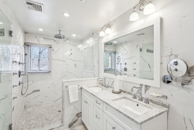 bathroom with a healthy amount of sunlight, visible vents, and a sink