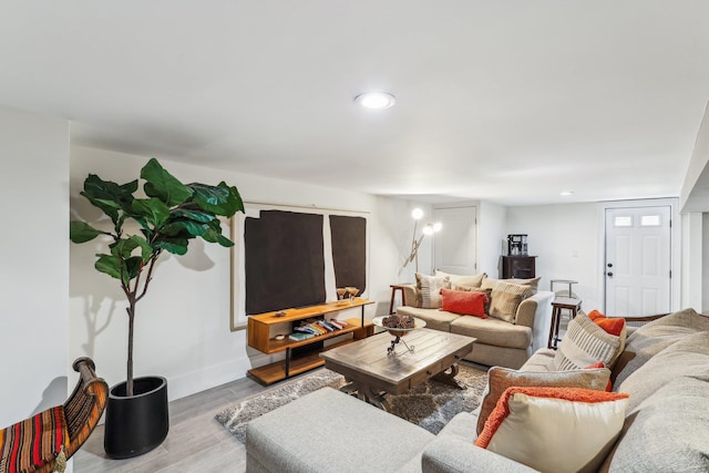 living area featuring recessed lighting, baseboards, and wood finished floors