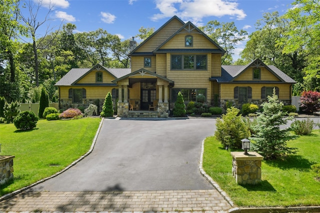 5 Danville Dr, Greenlawn, NY 11740 - craftsman house featuring stone siding, asphalt driveway, a front yard, and french doors
