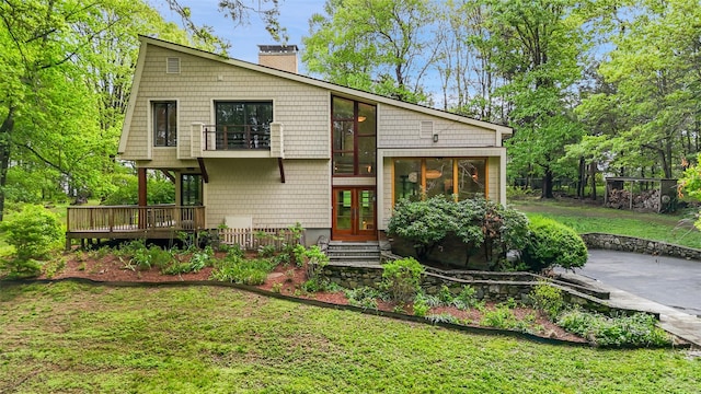 25 Moseman Ave, Katonah, NY 10536 - back of house featuring a chimney, a lawn, a balcony, french doors, and a deck