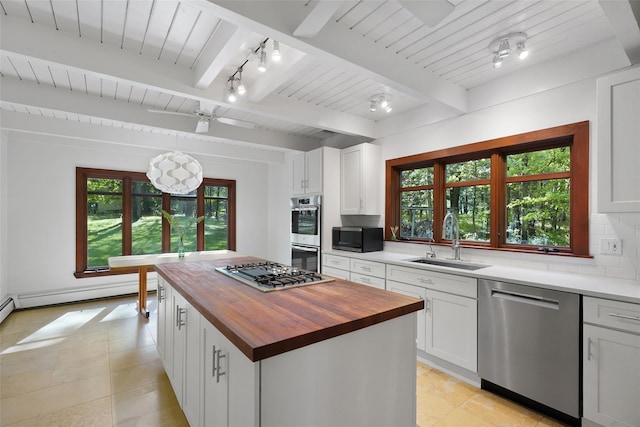 25 Moseman Ave, Katonah, NY 10536 - kitchen featuring stainless steel appliances, wood counters, a sink, plenty of natural light, and beam ceiling
