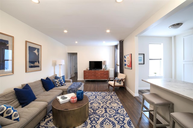 living room featuring recessed lighting, dark wood-style flooring, and baseboards