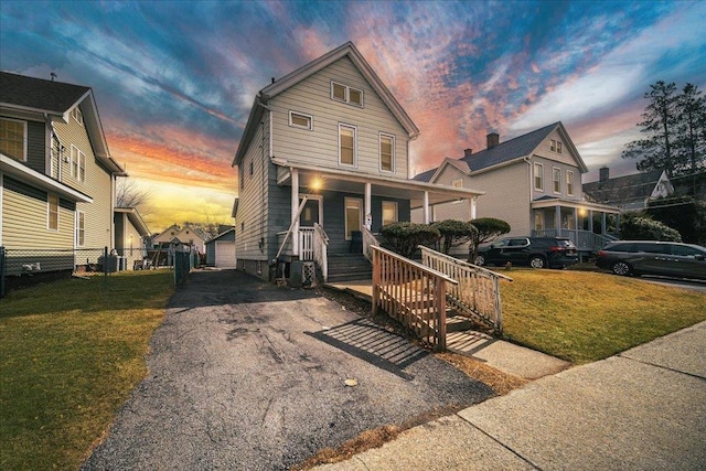 view of front facade with a lawn and covered porch