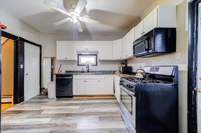 kitchen featuring stainless steel range with gas cooktop, black microwave, dishwasher, white cabinetry, and a sink