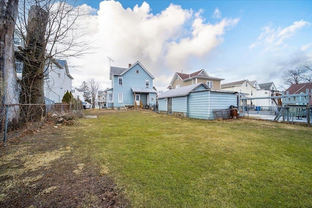 view of yard featuring a residential view and fence