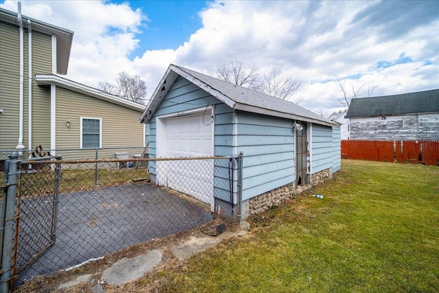 view of outdoor structure with an outbuilding, fence, and driveway