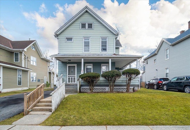 view of front of property with covered porch and a front lawn