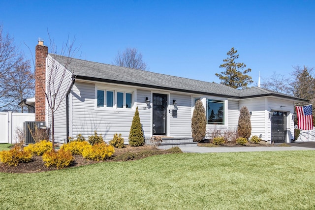 single story home featuring a front yard, fence, an attached garage, a shingled roof, and a chimney