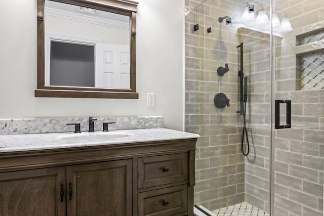 full bathroom with a stall shower, vanity, and ornamental molding