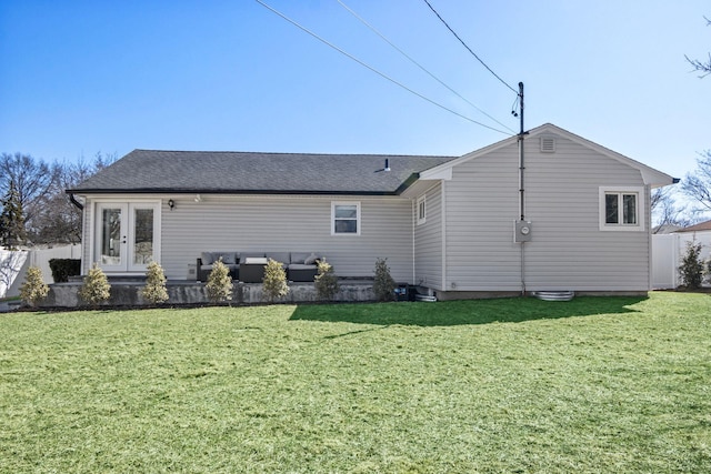 rear view of house with french doors, an outdoor hangout area, a yard, and fence