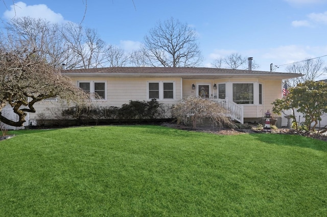 back of house with a lawn