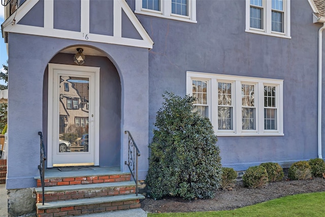 doorway to property with stucco siding