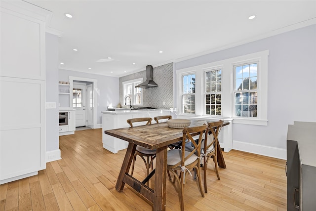 dining area with recessed lighting, baseboards, and light wood finished floors