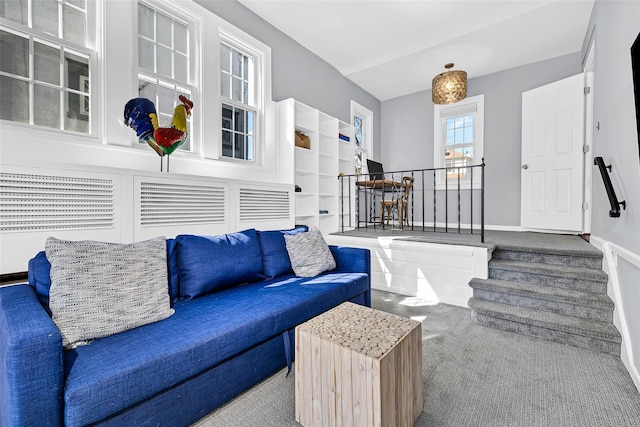 carpeted living room with baseboards