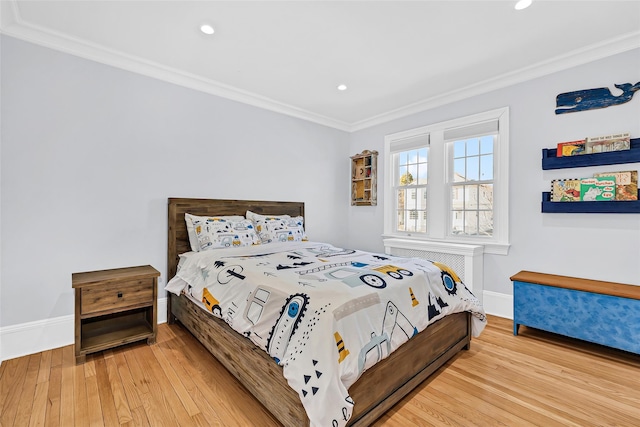 bedroom with recessed lighting, crown molding, baseboards, and wood finished floors