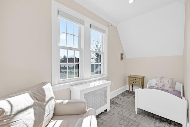 bedroom featuring lofted ceiling, radiator heating unit, carpet, and baseboards