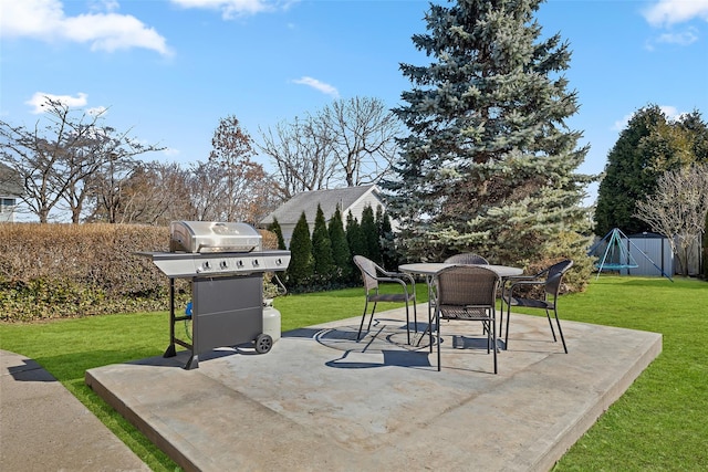 view of patio / terrace with grilling area, outdoor dining space, and fence