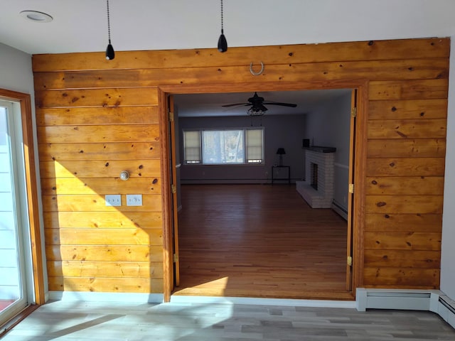 corridor featuring a baseboard radiator and wood finished floors