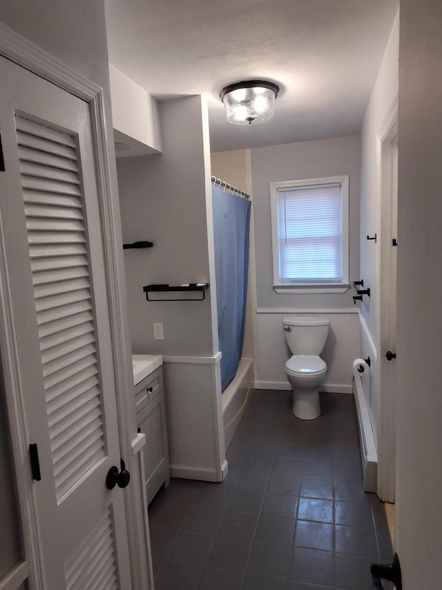 full bathroom with toilet, shower / bath combo, vanity, and wainscoting