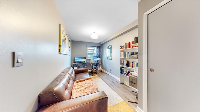 office with light wood-style flooring and baseboards