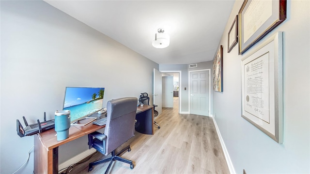 office space with light wood-style floors and baseboards