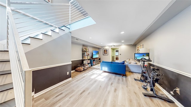 interior space featuring wainscoting, visible vents, wood finished floors, and recessed lighting