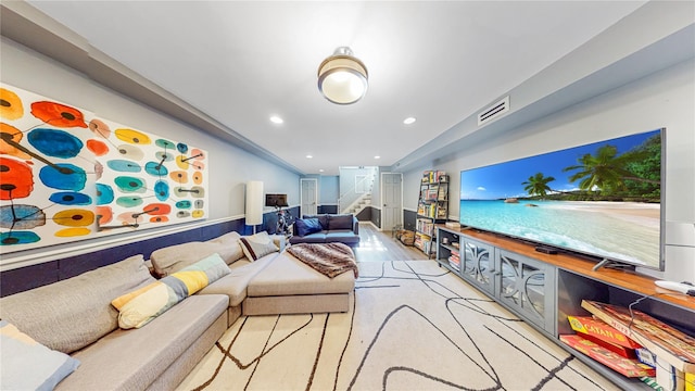 living room featuring light wood-style floors, recessed lighting, visible vents, and stairway