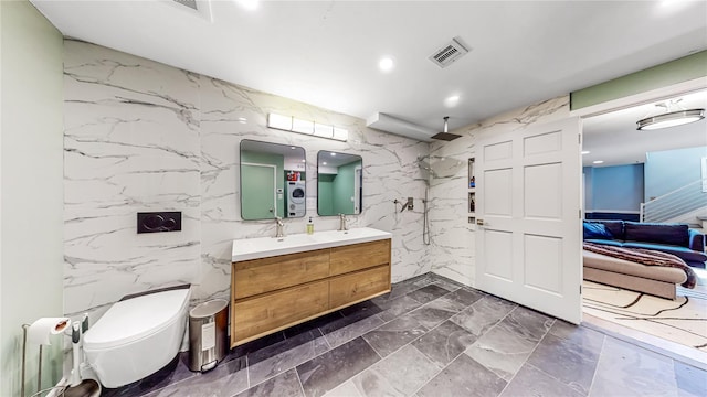 full bath featuring stone wall, toilet, visible vents, double vanity, and walk in shower