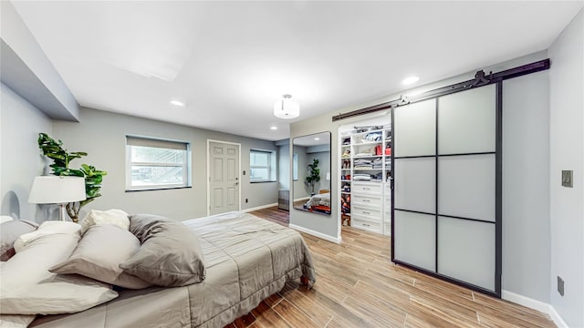 bedroom with light wood finished floors, recessed lighting, and baseboards