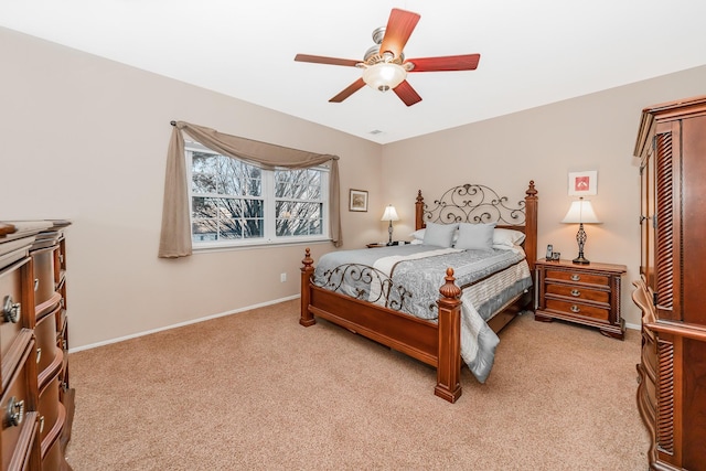 bedroom featuring light carpet, a ceiling fan, and baseboards